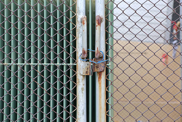 istock Wire link fence and metal door with closed 598668496