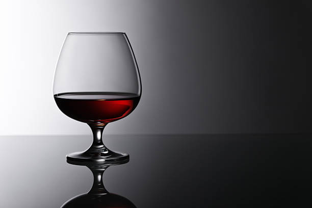 istock snifter of brandy on glass table 598673422