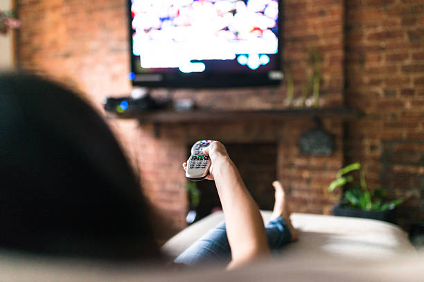 istock woman relaxing online on sofa reading some papers 598674302