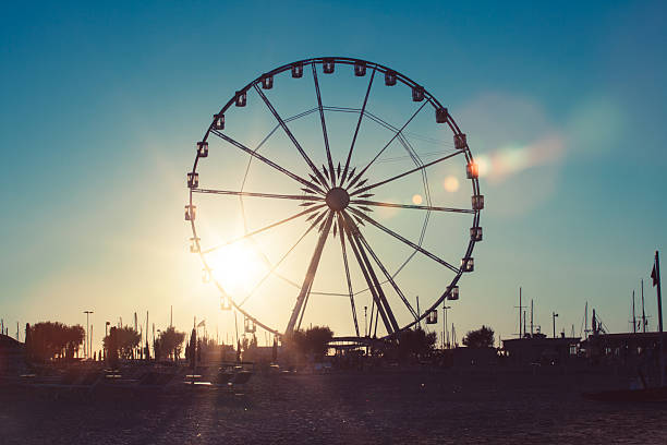 Ferris Wheel in Rimini Silhouetted ferris wheel at the harbor of Rimini, Italy rimini stock pictures, royalty-free photos & images