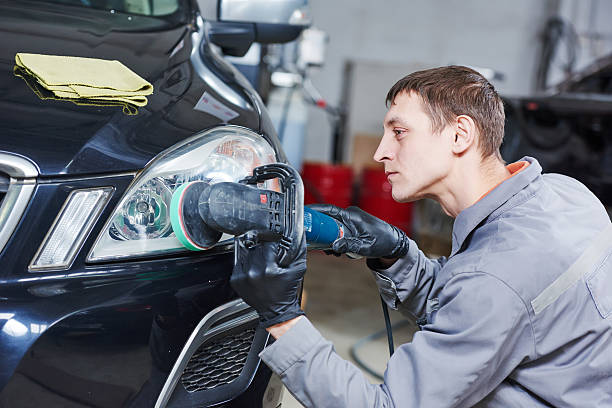 istock auto mechanic buffing and polishing car headlight 598675736