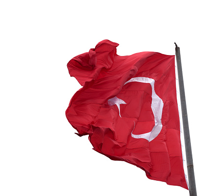 Waving in wind flag of Turkey on flagpole. Isolated on white background.