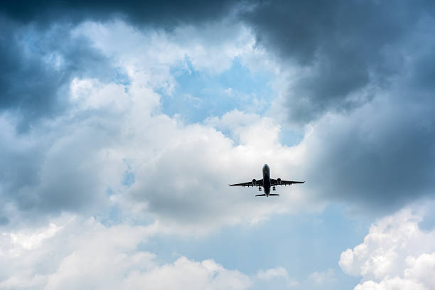 istock Airplane in the dark skies before storm. 598675998