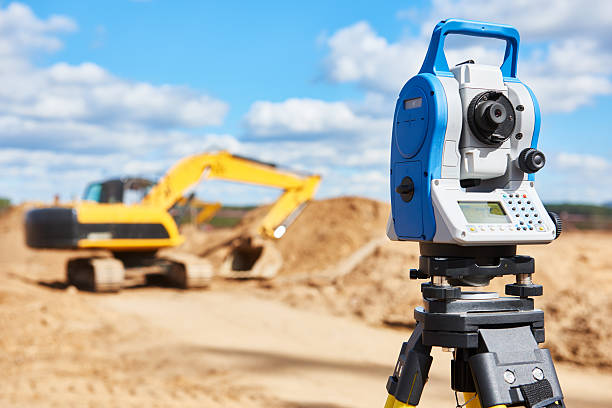istock surveyor equipment theodolie at construction site with excavator 598676148