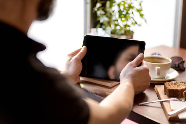 Young man using a touch screen tablet