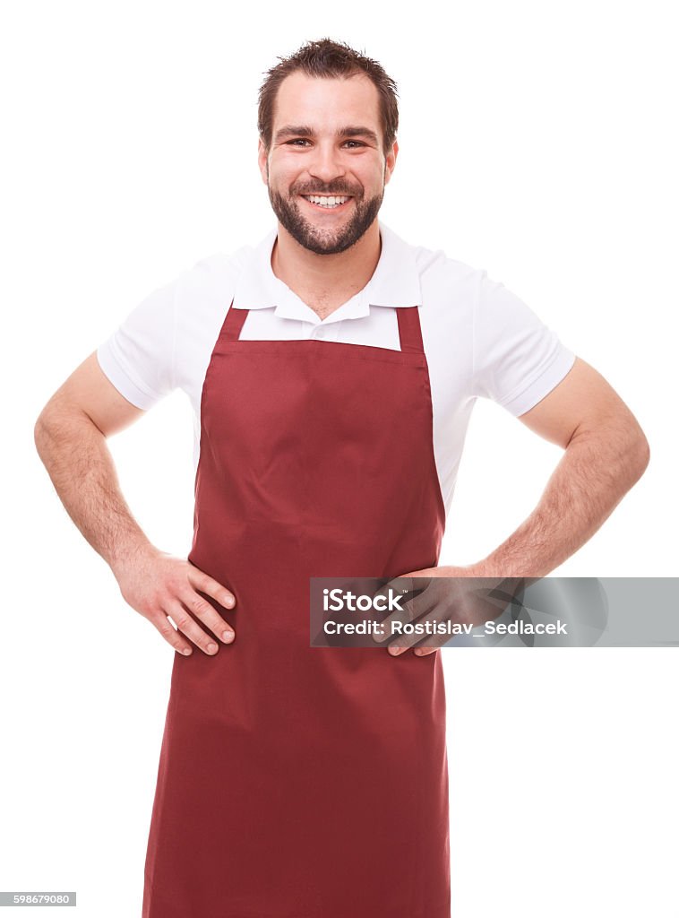 Smiling man with red apron Smiling man with red apron on white background Butcher Stock Photo