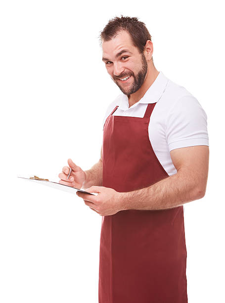istock Man with red apron writes on a black clipboard 598680146