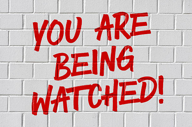 istock Graffiti on a brick wall - You are being watched 598680816