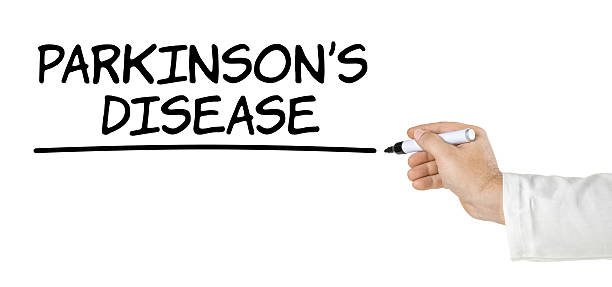 istock Hand with pen writing Parkinsons Disease 598680932