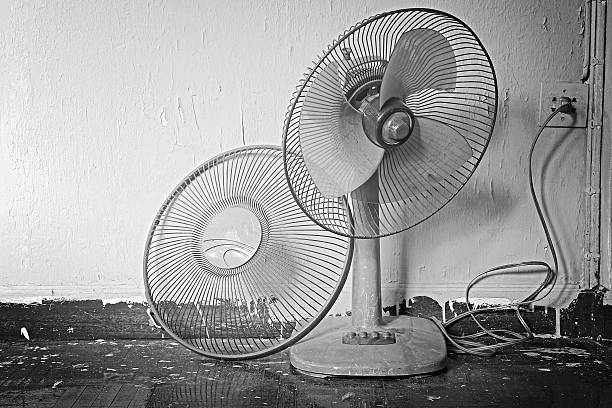 Dirty broken old electric fan in hot weather. Process in Black and White color