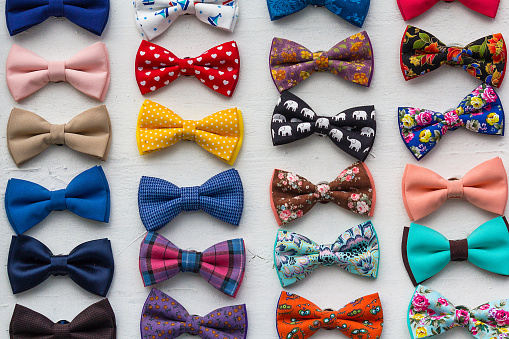 Сolorful bow ties are located in the window. Styles
