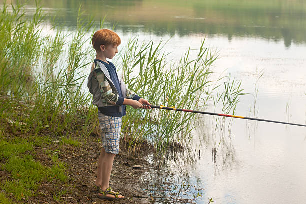 istock Young boy fishing in a lake 598683886