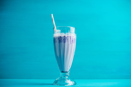 Blueberry milkshake on the wooden background