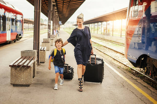 istock Cute little boy and mother on a railway station 598684554