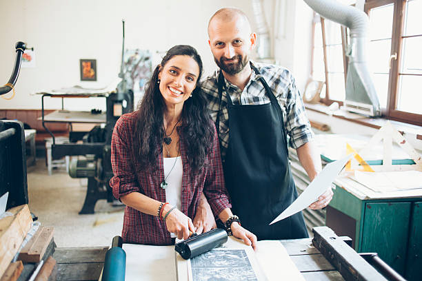 istock Cheerful lithography couple creating new pattern at printing house 598685496