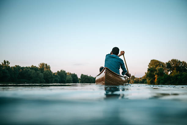 Enjoying a boat ride Couple enjoying a boat ride on the lake. canoeing stock pictures, royalty-free photos & images