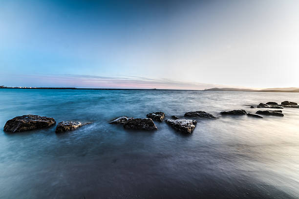 istock motion blur in Alghero shoreline on a clear night 598688180