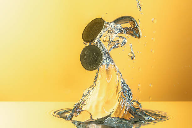 istock Euro coins moving from water with splash 598688714