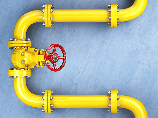 Yellow gas pipeline valve on a blue wall.