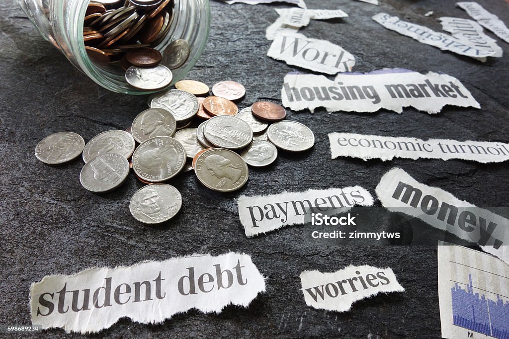 Bad news headlines Assorted economy related newspaper headlines with coin jar Currency Stock Photo