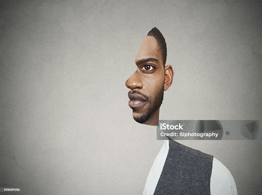 surrealistic portrait front with cut out profile of man surrealistic portrait front with cut out profile of a young man isolated on grey wall background Change Stock Photo