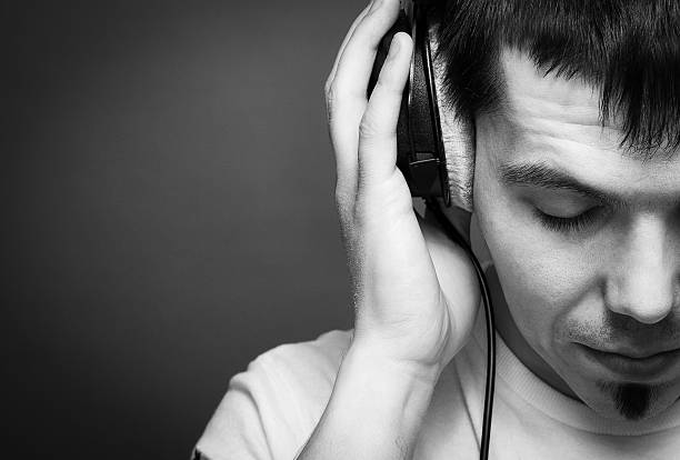 istock Young man with headphones on a gray background 598689300
