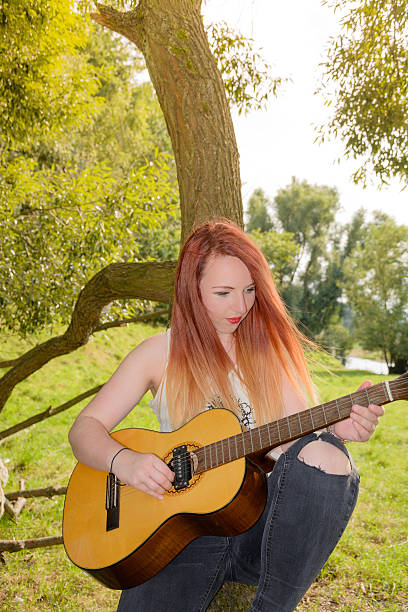 istock woman with guitar 598689368