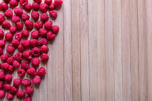 A lot of rapsberry on a wooden background