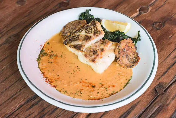 Pan-seared red snapper on delicious soup and spinach