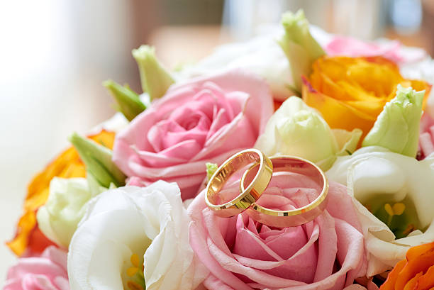 istock Bouquet flowers and weddings rings, close up 598698230