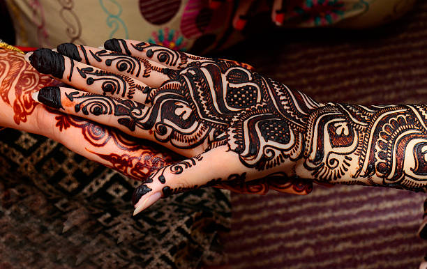 beautifully decorated indian hands with mehandi typically done for weddings stock photo