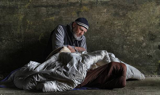 homeless man sleeping rough stock photo