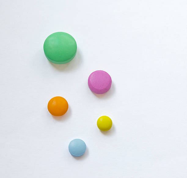 istock Multicolored medicine pills on white background 598698748