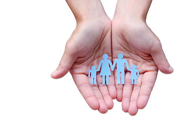 istock Paper family in hands isolated on white background welfare concept 598699334