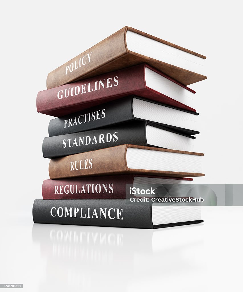 Book of Compliance Leather covered book of compliance. Stack of books on top of each other with business words written on their spines. Isolated on white background with clipping path. Law Stock Photo