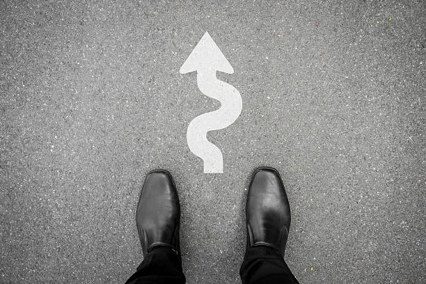 istock Businessman with hard way ahead sign 598702198