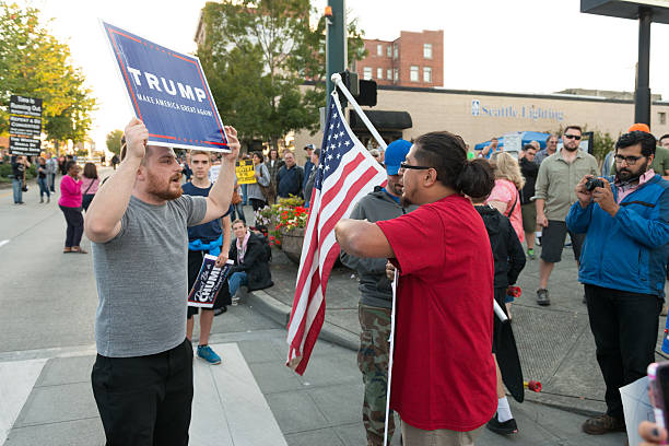 Trump Protest Everett, USA - August 30, 2016: A heated exchange between a Hillary and Trump supporter at the Donald Trump rally outside the Xfinity Arena in Everett late in the day. everett washington state photos stock pictures, royalty-free photos & images