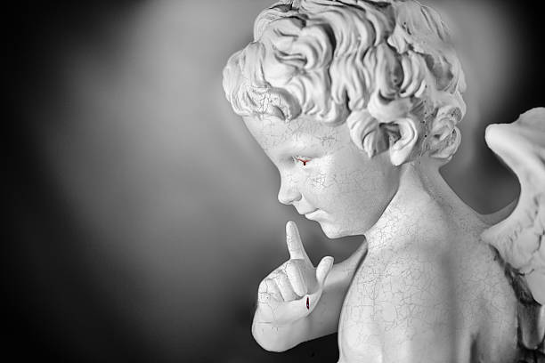 istock Heartbroken cupid statue crying with bloody tear 598703320