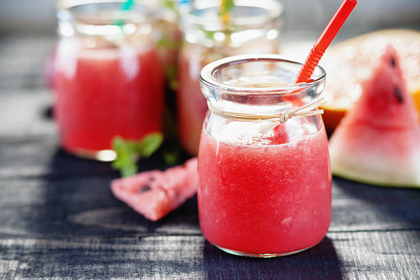 Watermelon smoothie Watermelon smoothie on a black table watermelon juice stock pictures, royalty-free photos & images