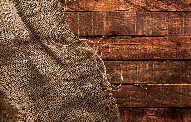 Burlap texture on wooden background Burlap texture on wooden table background. Wooden table with sacking hessian texture stock pictures, royalty-free photos & images