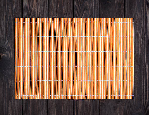 istock Bamboo mat on wooden table, top view 598704540