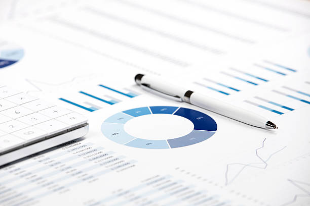 Pen and business chart on the printed media