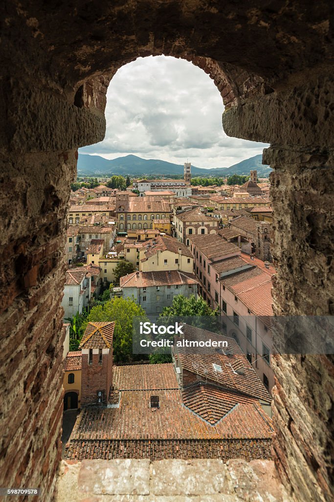 view from Torre dei Guinigi lucca Tuscany The city of Lucca in Tuscany, Italy, is famous for its medieval architecture and intact city walls.  The Torre Guinigi (english: Guinigi Tower) is a 44.5 meter high tower with oak trees on the top. Beautiful view over the old roofs of lucca. Lucca Stock Photo