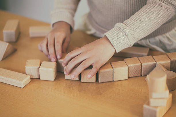 istock child playing with wooden blocks 598709912