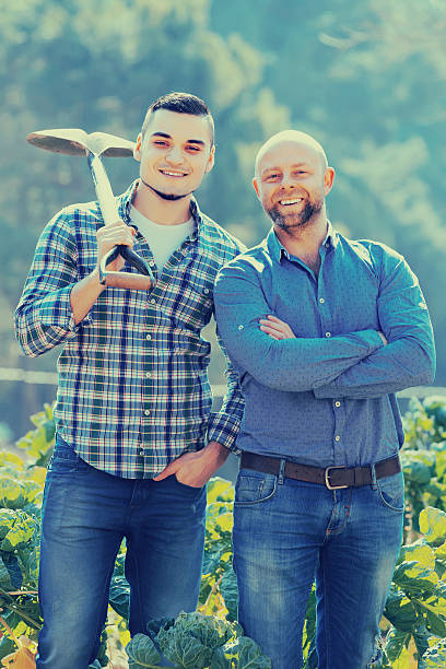 istock Farmers with spades at plantation 598712842