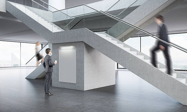 istock Three businesspeople in office lobby 598715378