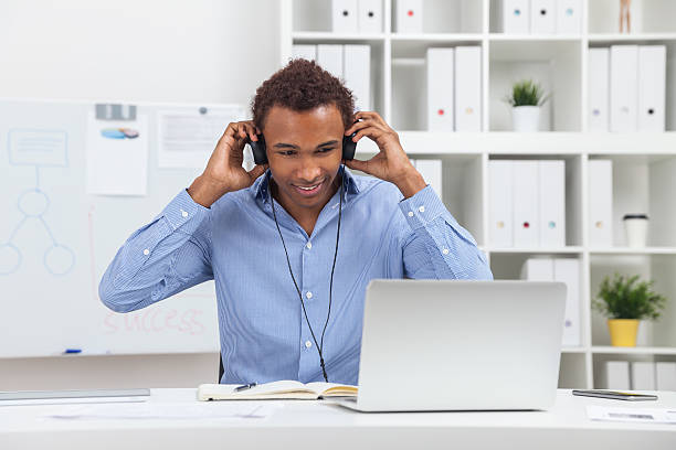 istock Man in headphones with laptop 598716248