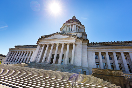 Subject: The Washington state capitol building exterior, it houses the State Senate, House of Representatives, the office of the Governor. Located in Olympia, Washington. Photographed in horizontal format.