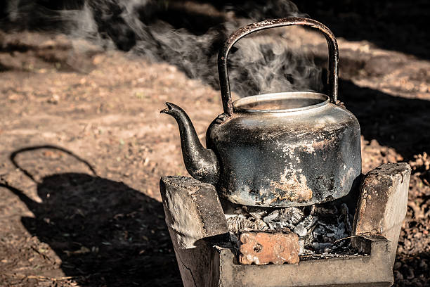 old aluminium kettle on stove. old aluminium kettle on stove. people is boiling water at the countryside in the sunset morning kitchen utensil antique toaster old stock pictures, royalty-free photos & images