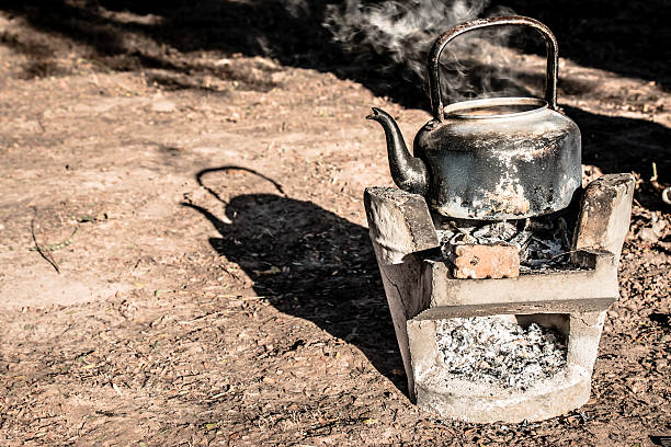 old aluminium kettle on stove. old aluminium kettle on stove. people is boiling water at the countryside in the sunset morning kitchen utensil antique toaster old stock pictures, royalty-free photos & images